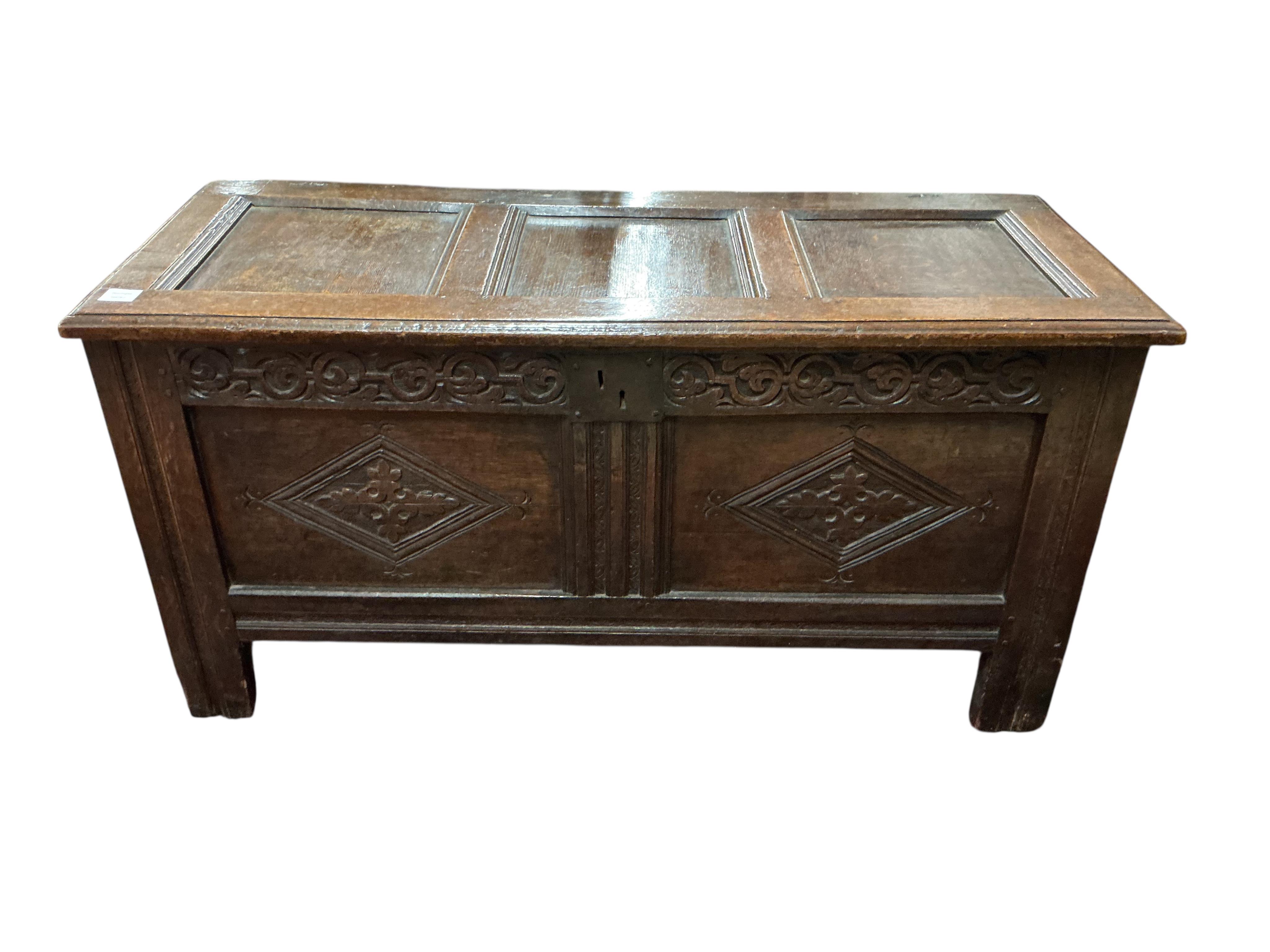 A 17th century oak coffer, the panelled front carved with lozenges, width 126cm, depth 51cm, height 64cm